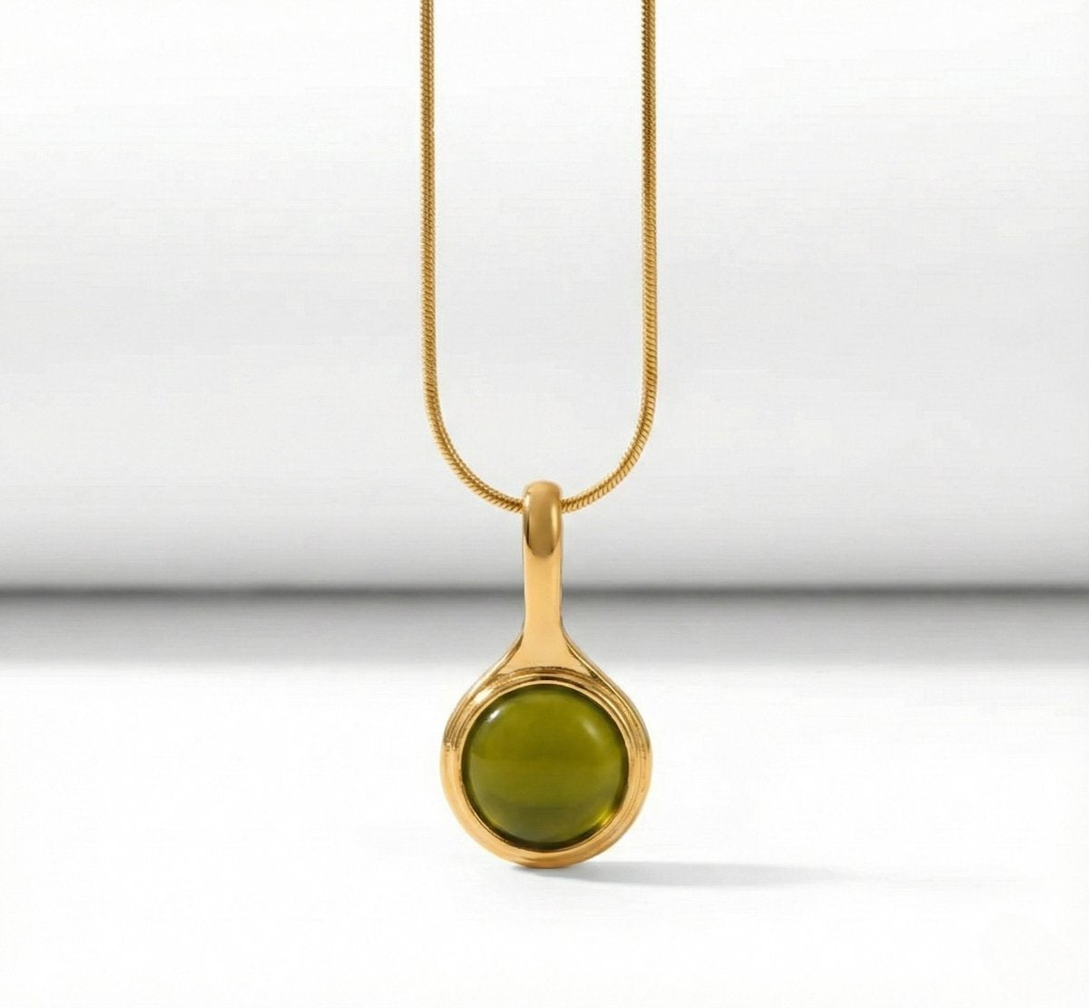 Lundholm Cecile Serie ketting voor dames in goudkleurig met groene natuursteen hanger in close-up, gemaakt van premium stainless steel met PVD coating van 2.5 micron, waterproof en hypoallergeen, perfect cadeau voor vrouw, moederdag of verjaardag in Scandinavisch design.