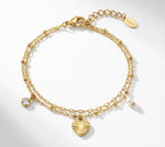 Lundholm My Lizzy Serie dubbel laags bedel armband dames goudkleurig met hartje hanger en zirkonia charm productfoto witte achtergrond - waterproof gold plated PVD premium stainless steel sieraden cadeau vrouw moederdag verjaardag Scandinavisch Design