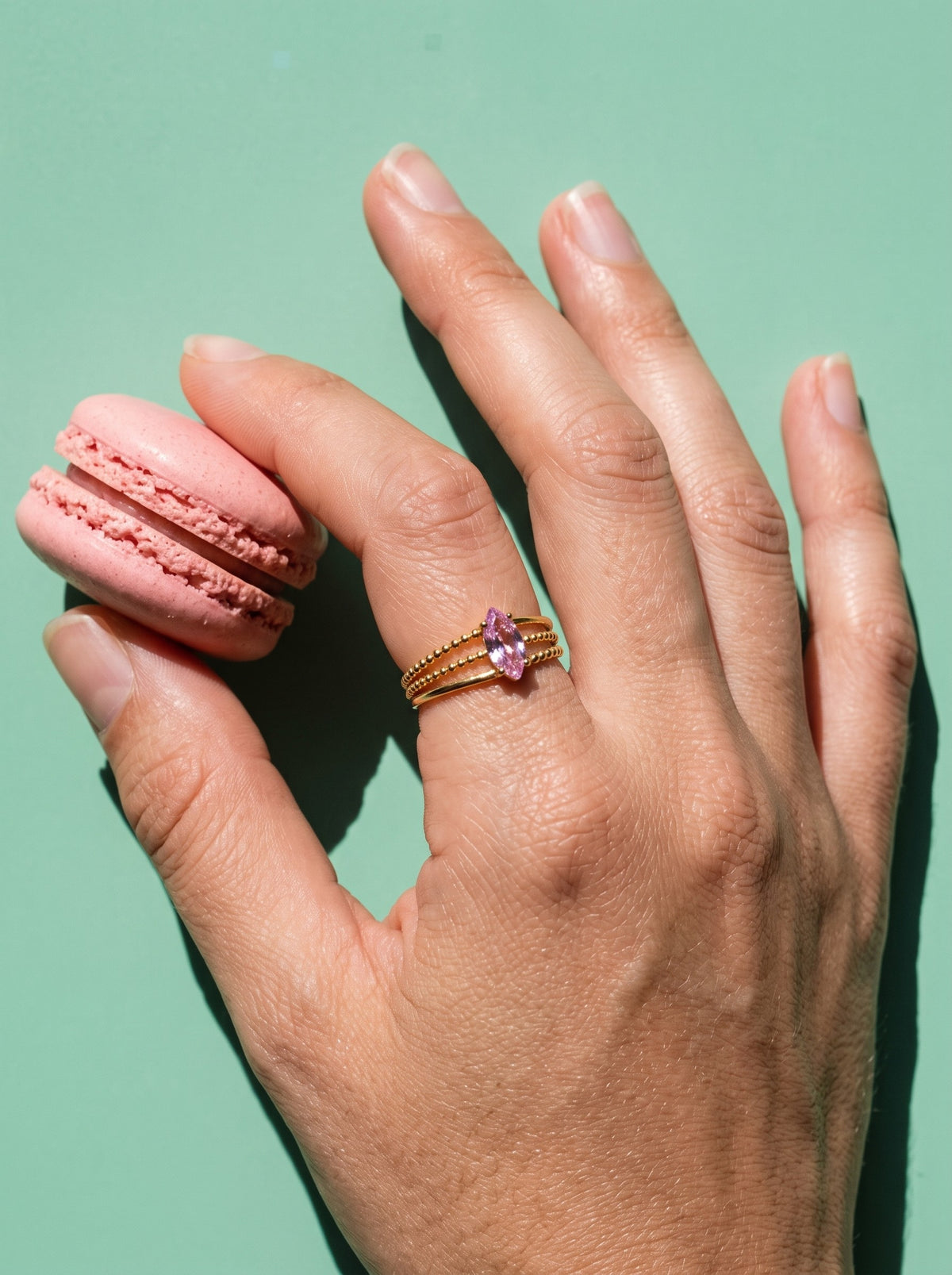 Lundholm Juliette verstelbare ring met roze natuursteen goudkleurig gedragen, met een roze macaron